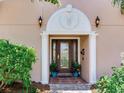 Covered front entrance with beautiful glass windows and detailed trim at 8 Sunset Bay Dr, Belleair, FL 33756
