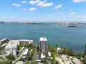 High-angle daytime view featuring white condos with parking and a beautiful ocean and cityscape at 80 Rogers St # 3A, Clearwater, FL 33756