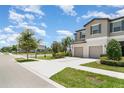 Beautiful townhome with a large driveway, attached garage and landscaping at 9741 Mulberry Marsh Ln, Sun City Center, FL 33573