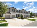 Attractive townhomes featuring a neutral color scheme, attached garages and well-manicured landscaping at 9741 Mulberry Marsh Ln, Sun City Center, FL 33573