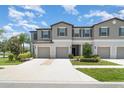 Inviting townhomes with attached garages, neutral exteriors and green landscaping at 9741 Mulberry Marsh Ln, Sun City Center, FL 33573