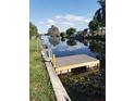 A scenic waterfront view with a new dock for enjoying outdoor activities and serene water reflections at 10160 118Th Ave, Largo, FL 33773