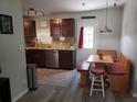 Cozy kitchen featuring wood cabinets, granite counters, stainless appliances, and dining nook at 10160 118Th Ave, Largo, FL 33773