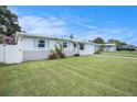 Inviting single-story home with a bright exterior, blue shutters, and a lush green lawn at 11416 126Th N Ave, Largo, FL 33778