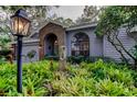 Beautiful home featuring lush landscaping, brick accents, and an inviting entrance at 11760 Ashley Ct, Seminole, FL 33772