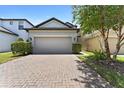 Charming two-story home with a two-car garage, brick driveway, and well-maintained landscaping at 1604 Acadia Harbor Pl, Brandon, FL 33511