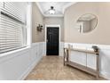 Inviting foyer with tile flooring, decorative mirror, and a view of the home's interior at 1604 Acadia Harbor Pl, Brandon, FL 33511