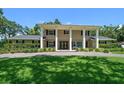 Striking home with symmetrical design, prominent columns, manicured lawn, and inviting curb appeal at 1681 Long Bow Ln, Clearwater, FL 33764