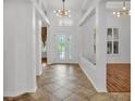 Bright foyer with tile flooring, decorative lighting, and open layout with views of the home at 2202 Hickory Ridge Dr, Valrico, FL 33596