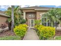 Inviting front entrance with well-kept landscaping and walkway leading to the front door at 2202 Hickory Ridge Dr, Valrico, FL 33596