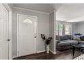 Inviting foyer with decorative front door, wood floors and gray walls at 2584 58Th S Ave, St Petersburg, FL 33710