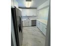Bright kitchen features white cabinets, stainless appliances, and modern countertops at 2625 State Road 590 # 1512, Clearwater, FL 33759