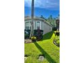 Lush green lawn and mature landscaping highlight the side of this well-maintained home at 27312 Edenfield Dr, Wesley Chapel, FL 33544