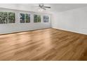 Bright and spacious living room featuring lots of windows for natural light and attractive wood flooring at 2908 Lockwood Meadows Blvd, Sarasota, FL 34234