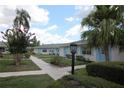 Scenic view of the community featuring sidewalks, mature trees, and well-maintained landscaping at 402 Dorchester Pl # 44, Sun City Center, FL 33573