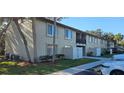 Exterior view with assigned parking, mature trees, and building balconies at 4215 E Bay Dr # 1506C, Clearwater, FL 33764