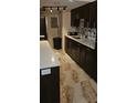 Modern kitchen with white countertops, dark cabinets, and stylish tile flooring at 4215 E Bay Dr # 1506C, Clearwater, FL 33764
