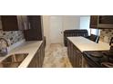 Updated kitchen with white countertops, dark cabinets, and modern appliances at 4215 E Bay Dr # 1506C, Clearwater, FL 33764
