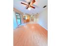 Bright and airy living room with hardwood floors and sliding door access to the patio at 4306 Woodside Manor Dr, Tampa, FL 33624