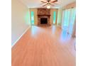 Cozy living room with a stone fireplace and a ceiling fan at 4306 Woodside Manor Dr, Tampa, FL 33624