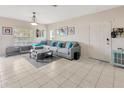 Inviting living room with neutral tones, tiled floors, and a comfortable sectional sofa, great for relaxation at 4703 Somerset Hill Ln, Riverview, FL 33578