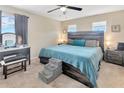 Cozy main bedroom featuring a rustic wood headboard, soft carpet, and calming colors for a restful retreat at 4703 Somerset Hill Ln, Riverview, FL 33578