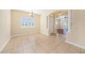 The dining room boasts tiled floors, a large window, and an arched entryway with decorative columns at 4760 Wheel House Dr, New Port Richey, FL 34652