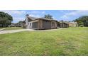 Spacious home exterior featuring a side-entry garage, manicured landscaping, and a well-maintained lawn at 513 Sportsman Park Dr, Seffner, FL 33584