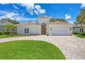 Beautiful, modern, single-story home with lush landscaping and a paver driveway, perfect for Gathering living at 5217 88Th E St, Bradenton, FL 34211
