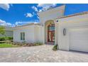 Close up view of this single-story home with a tile roof, lush landscaping and a paver driveway at 5217 88Th E St, Bradenton, FL 34211