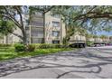 View of the condominium exterior, showcasing the well-maintained landscaping and covered parking area at 700 Starkey Rd # 1145, Largo, FL 33771