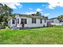 Quaint home featuring a red door and lush greenery in a serene setting at 812 W Orient St, Tampa, FL 33603