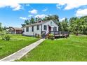 A single-story home with a walkway, front porch, and lush green lawn on a sunny day at 812 W Orient St, Tampa, FL 33603