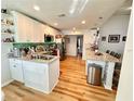 Well-lit kitchen featuring stainless steel appliances and a spacious granite-topped island at 8616 Pinafore Dr, New Port Richey, FL 34653