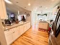 Bright, open kitchen featuring granite countertops and hardwood floors; perfect for entertaining at 8616 Pinafore Dr, New Port Richey, FL 34653