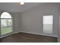 Bright bedroom with wood-look floors and windows offering ample natural light and a pleasant view at 11227 Thicket Ct, Tampa, FL 33624