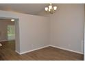Dining room with wood-look floors, modern lighting, and a spacious layout for gatherings at 11227 Thicket Ct, Tampa, FL 33624