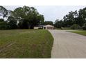 Single story home featuring a large front yard and a long concrete driveway to the attached two car garage at 11308 Echo View Dr, Odessa, FL 33556