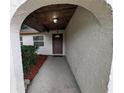 Arched entryway leading to a brown front door with a decorative window and well-kept landscaping at 11308 Echo View Dr, Odessa, FL 33556