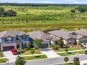 Neighborhood aerial view featuring a single Gathering home and green spaces in the surrounding area at 11745 Brighton Knoll Loop, Riverview, FL 33579
