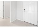 Clean entryway featuring white walls, and a white front door, with tile flooring at 11745 Brighton Knoll Loop, Riverview, FL 33579