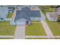 Single-story home with a two-car garage, neutral color scheme, fenced yard, and gravel landscaping at 13916 Briardale Ln, Tampa, FL 33618