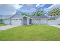 Charming single-story home featuring a well-manicured lawn, tidy landscaping, and attached two-car garage at 13916 Briardale Ln, Tampa, FL 33618