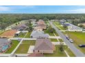 An aerial view displaying the neighborhood's layout, showcasing homes, streets, and surrounding greenery at 15442 Arvin Dr, Brooksville, FL 34604