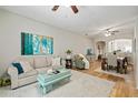 Inviting living room featuring a plush rug, comfortable sofa, and stylish decor with an adjacent dining area at 2349 Willimette Dr, Wesley Chapel, FL 33543