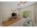 Cozy living room with a view of the screened lanai and a neutral color palette, perfect for relaxation at 2349 Willimette Dr, Wesley Chapel, FL 33543