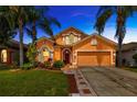 Charming two-story home with landscaped yard and a well-maintained two-car garage at 31241 Kirkshire Ct, Wesley Chapel, FL 33543