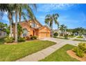 Well-maintained home with a lush lawn, mature trees and a spacious driveway at 31241 Kirkshire Ct, Wesley Chapel, FL 33543