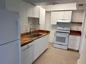 Bright kitchen features white cabinets, wood countertops, stainless steel sink and appliances at 320 N Bayshore Blvd # 203, Clearwater, FL 33759