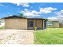 Inviting single-story home with a screened porch and lush green lawn at 3743 Cherrywood Dr, Holiday, FL 34691